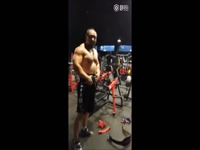 Shirless Asian bodybuilder in the gym