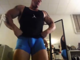 kevin blake flexing in blue spandex tights