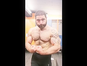 hairy guy flexing at the gym
