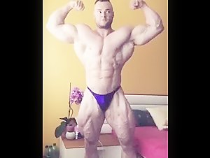 Bodybuilder Showing off in Purple Trunks