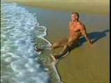 Bodybuilder poses nude on beach