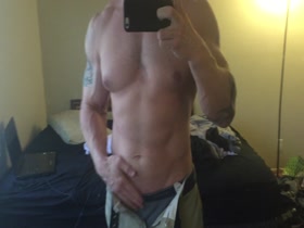 muscled guy shows off his cock and body