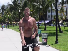 Big muscle guy on bicycle