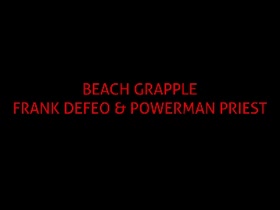 Beach hunks wrestling