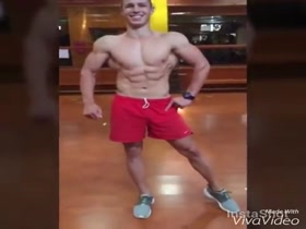 Two latin dudes physique posing in the gym