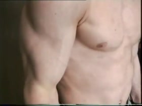 Young wrestler flexes with some touching