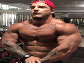 Macho posing  at gym