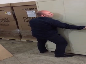 bodybuilder lift an iron cabinet