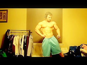 Cocky young bodybuilder flexes