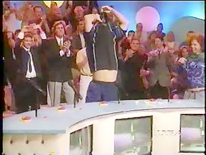 WWF or WCW Wrestler Takes Off Shirt