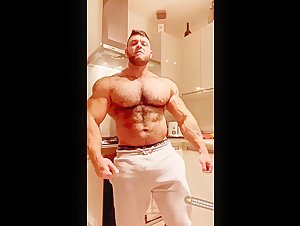 Cocky huge bodybuilder with sweatpants bulge