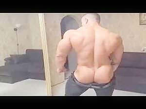 Bodybuilder poses with a hard cock