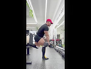 Asian bodybuilder in tight shorts and knee high socks